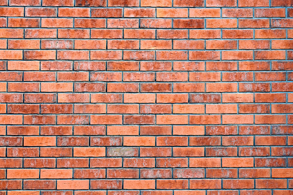 Red brick wall of loft building, red grunge brick wall background, loft texture pattern modern design. Masonry brickwork with red bricks and mortar