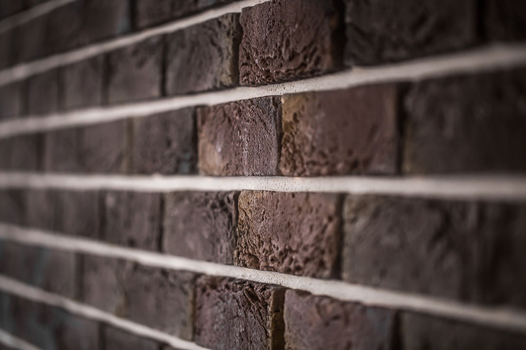 Beautiful brick wall, dark brown closeup ,background tuckpointing highland park